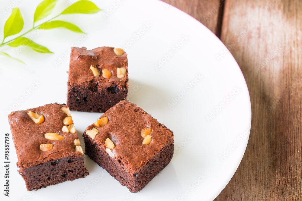 brownies and golden spoon with cup of coffee on table