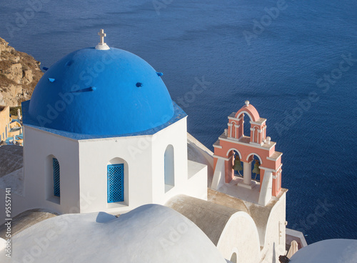 Santorini - church cupolas with the little bell tower in Oia over the caldera.