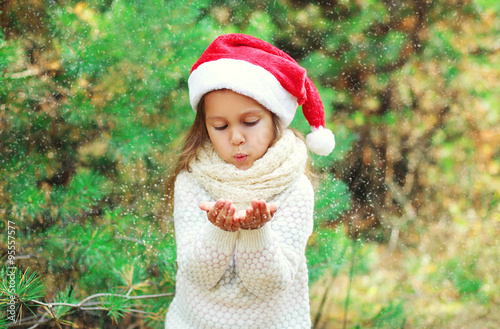 Christmas and people concept - little girl child in santa red ha