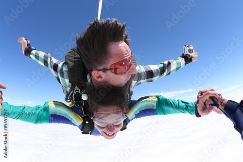 Skydiving tandem holding hands photo