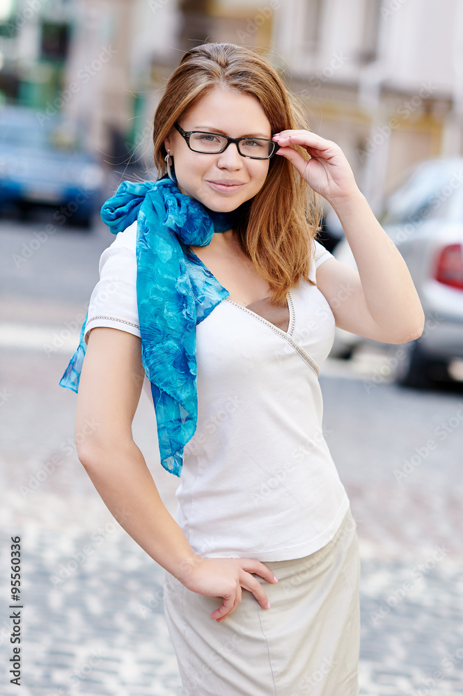 pretty young woman with glasses against a street background