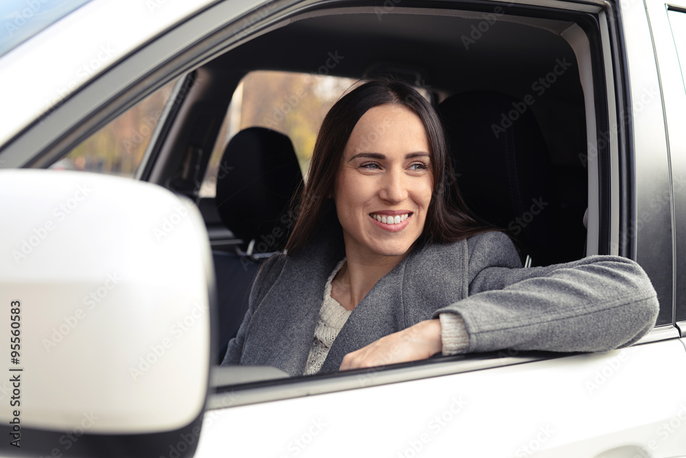 smiley young woman in the white car