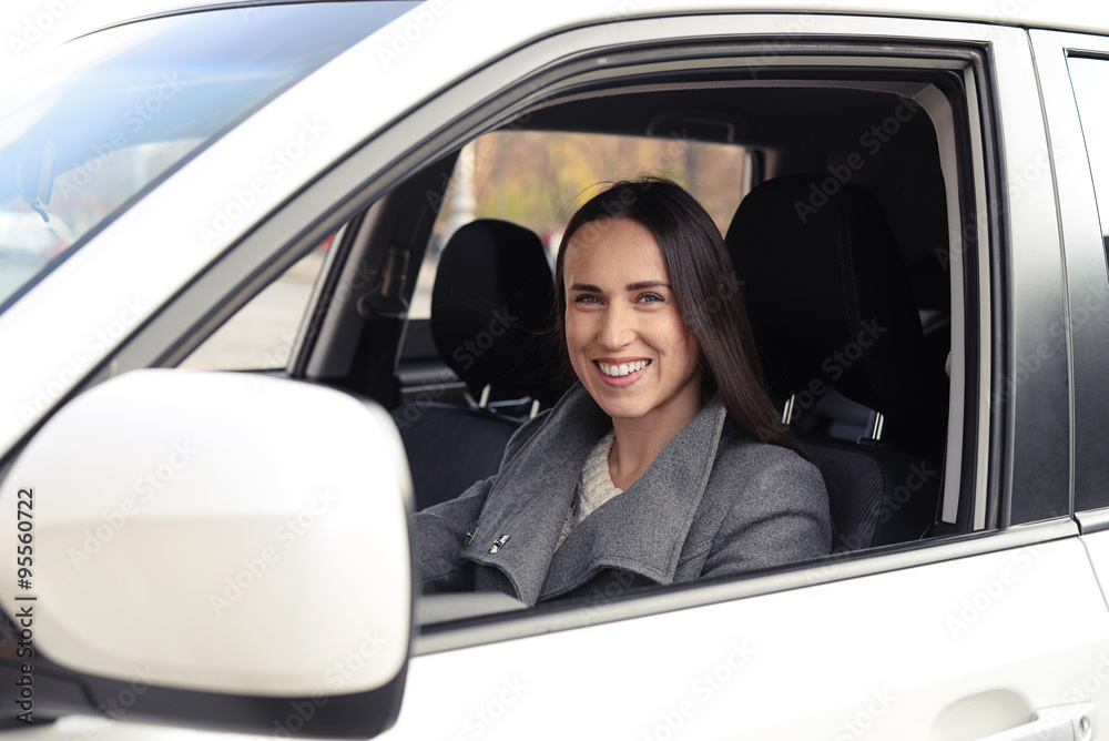 woman driving the car and smiling