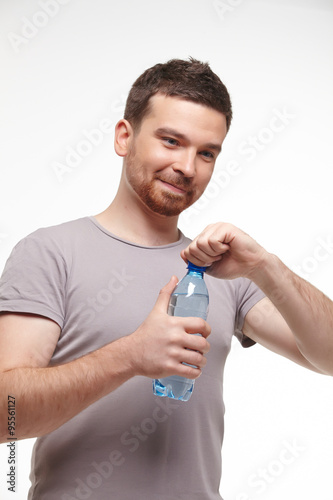 man opens a bottle of water
