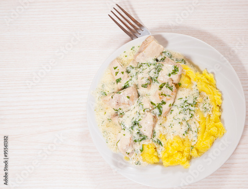 chicken breast in a creamy sauce with mashed potatoes