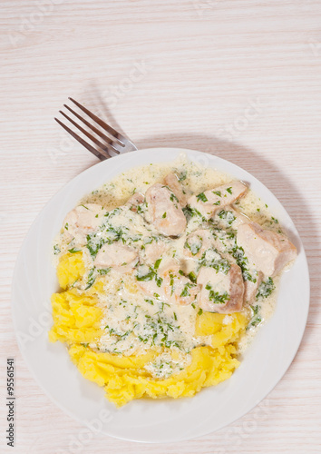 chicken breast in a creamy sauce with mashed potatoes