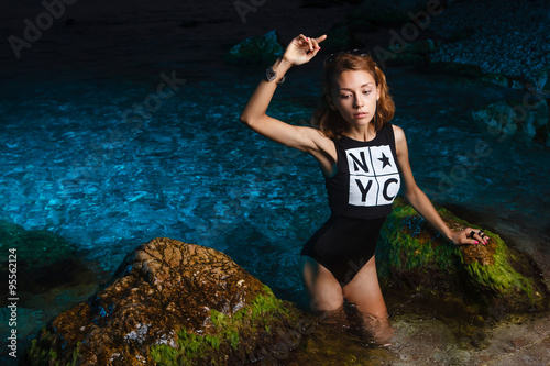 Fototapeta Naklejka Na Ścianę i Meble -  Young teen girl in sea fashion shoot at sunset beach