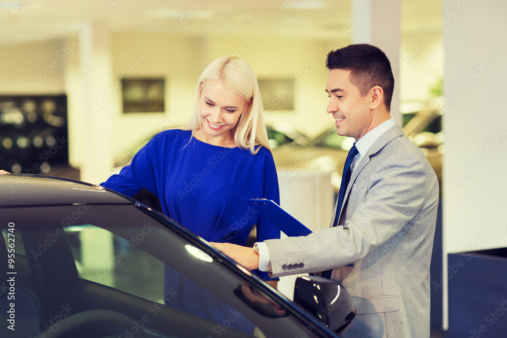 happy woman with car dealer in auto show or salon happy woman with car dealer in auto show or salon