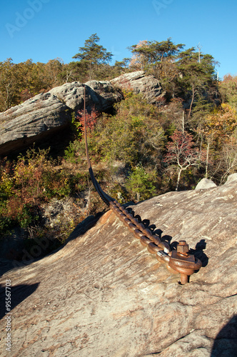 A chain is meant to keep a large boulder from falling on Pineville, Kentucky. photo