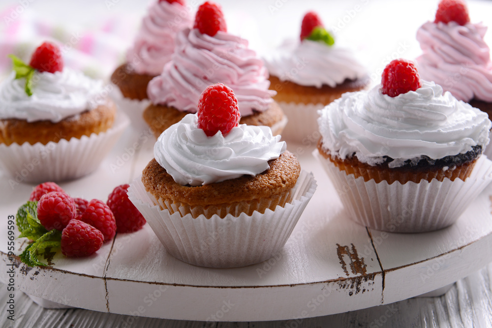 Delicious cupcakes with berries on table close up Delicious cupcakes with berries on table close up