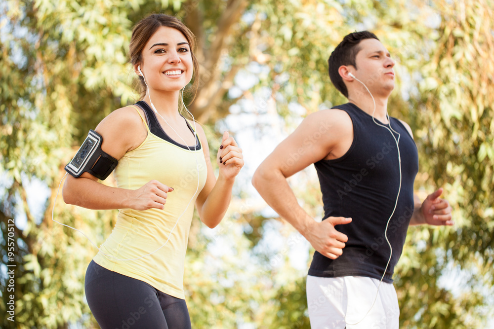 Fototapeta premium Couple running and listening to music