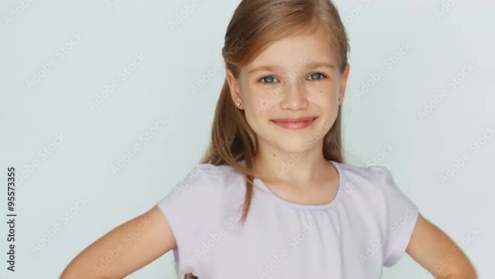 Thumbs up. Ok. Girl is on the white background. Laughing child. Closeup Thumbs up. Ok. Girl is on the white background. Laughing child. Closeup