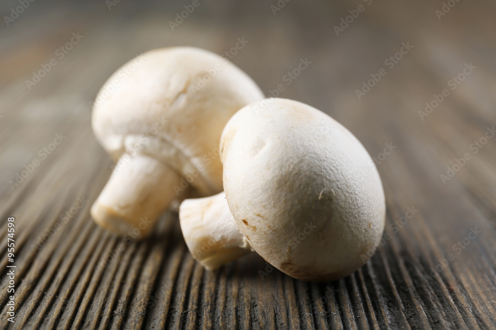 Champignon mushrooms on grey wooden background Champignon mushrooms on grey wooden background