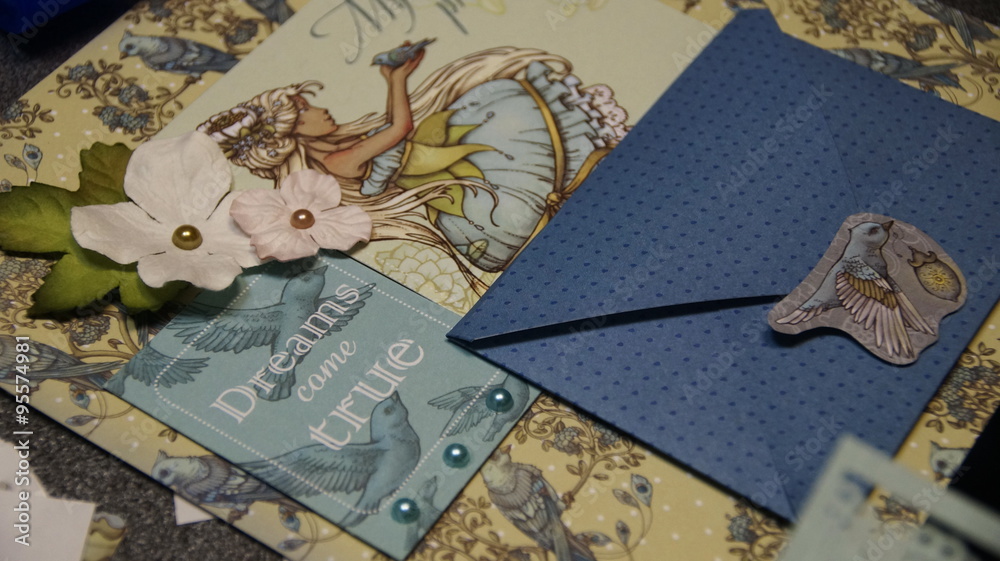 the process of handmade creating of the album from special scrapbooking paper, paper flowers and other decorative elements the process of handmade creating of the album from special scrapbooking paper, paper flowers and other decorative elements