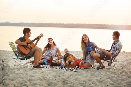 Carefree friends have fun on the beach © Africa Studio
