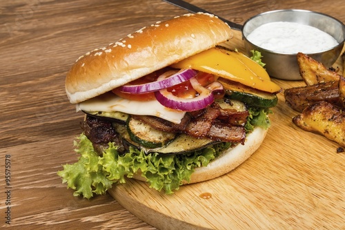 Fresh hamburger on wooden table. Stock image macro.