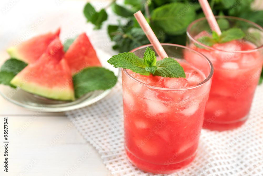 Cold watermelon desserts and drinks in glasses, on wooden table background Cold watermelon desserts and drinks in glasses, on wooden table background