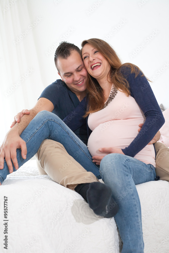 smiling pregnant couple smiling pregnant couple