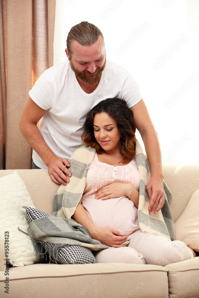 Handsome man takes care about his lovely pregnant woman Handsome man takes care about his lovely pregnant woman