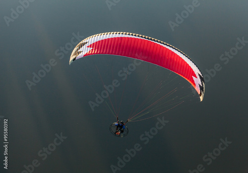 aerial view of paramotor flying over the river photo