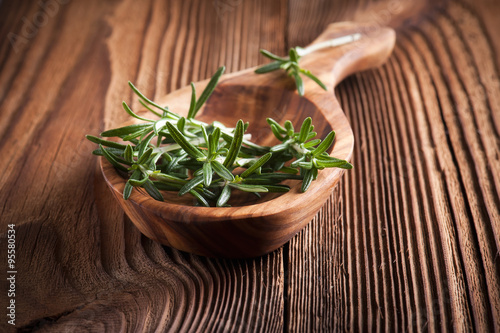 bunch of fresh rosemary on a wooden background