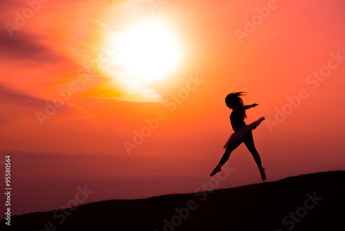 Fototapeta Naklejka Na Ścianę i Meble -  Ballerina in silhouette in a red sunset