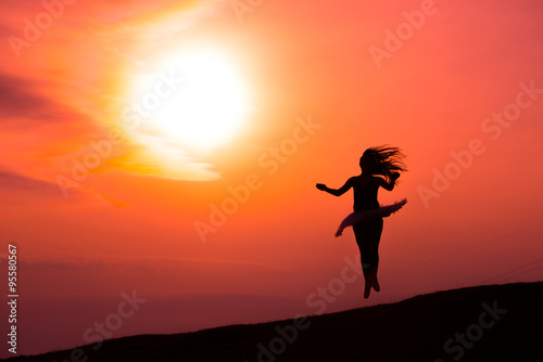 Ballerina in silhouette in a red sunset © michelangeloop