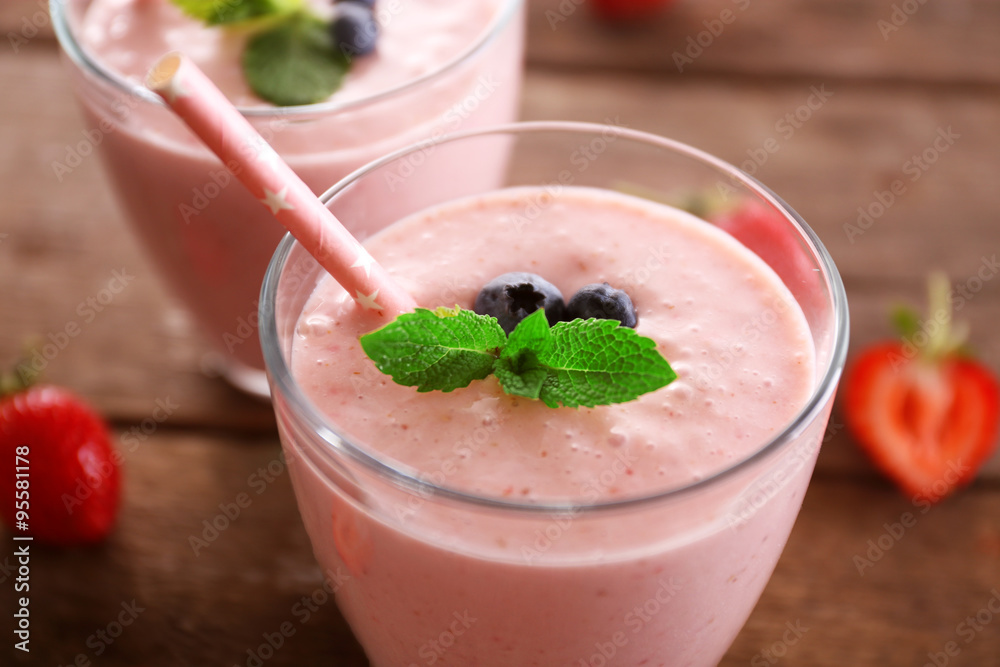 Fresh strawberry yogurt with berries around on wooden background Fresh strawberry yogurt with berries around on wooden background