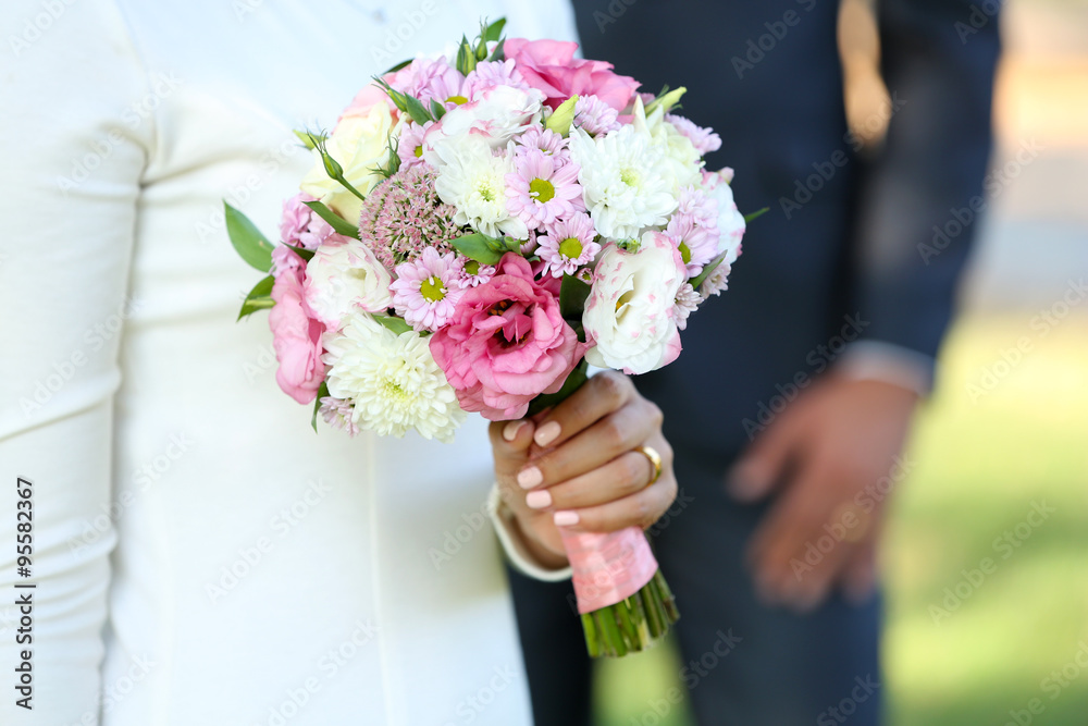 Bride with wedding bouquet and groom on nature background Bride with wedding bouquet and groom on nature background