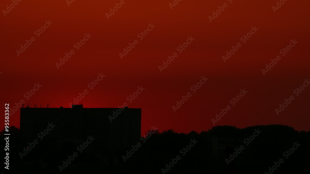 The sun rises up from behind the building in timelapse. Full HD 1080p The sun rises up from behind the building in timelapse. Full HD 1080p