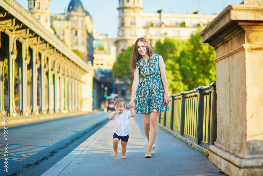 Beautiful young mother with her adorable in Paris, France