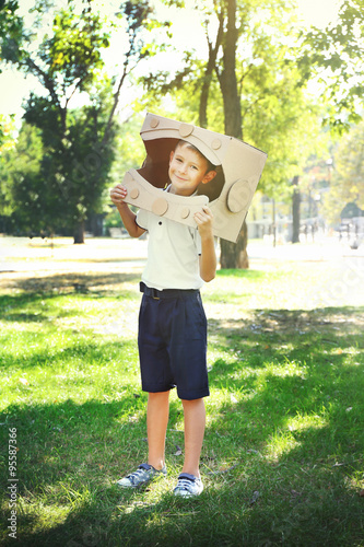 Funny boy in carton helmet plays in  the park © Africa Studio