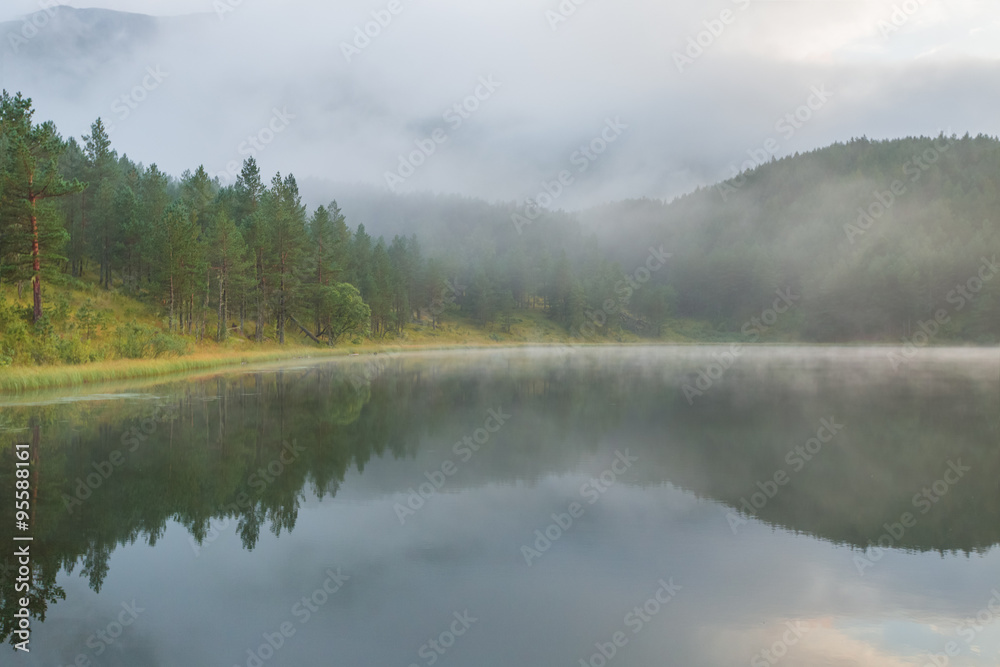 Foggy day at mountain lake