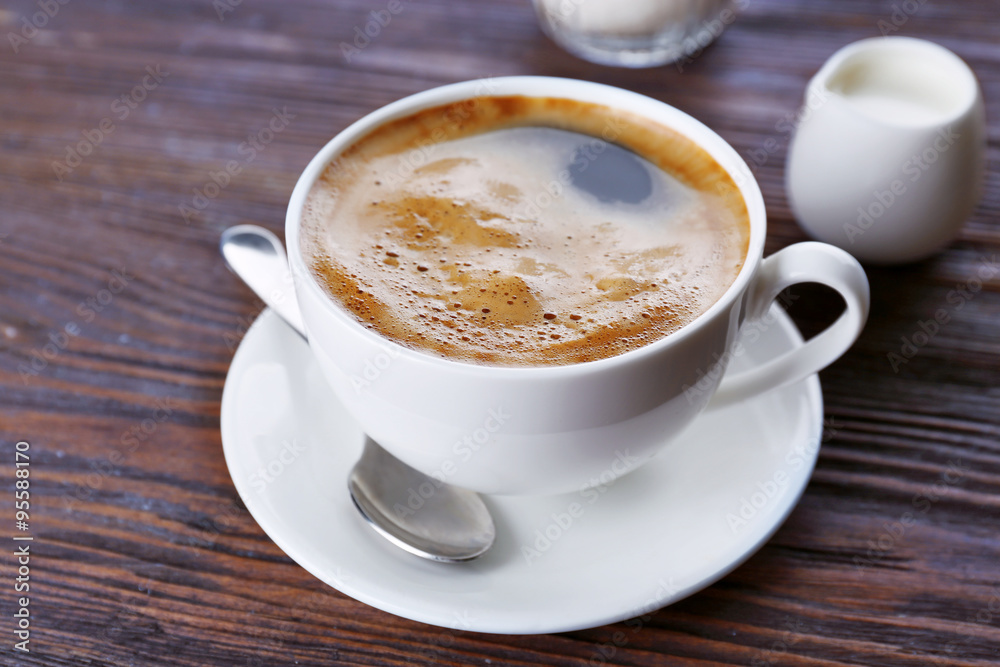 Cup of coffee with cream on wooden background Cup of coffee with cream on wooden background