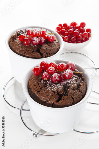 chocolate baked pudding with redccurent on white. healthy desser