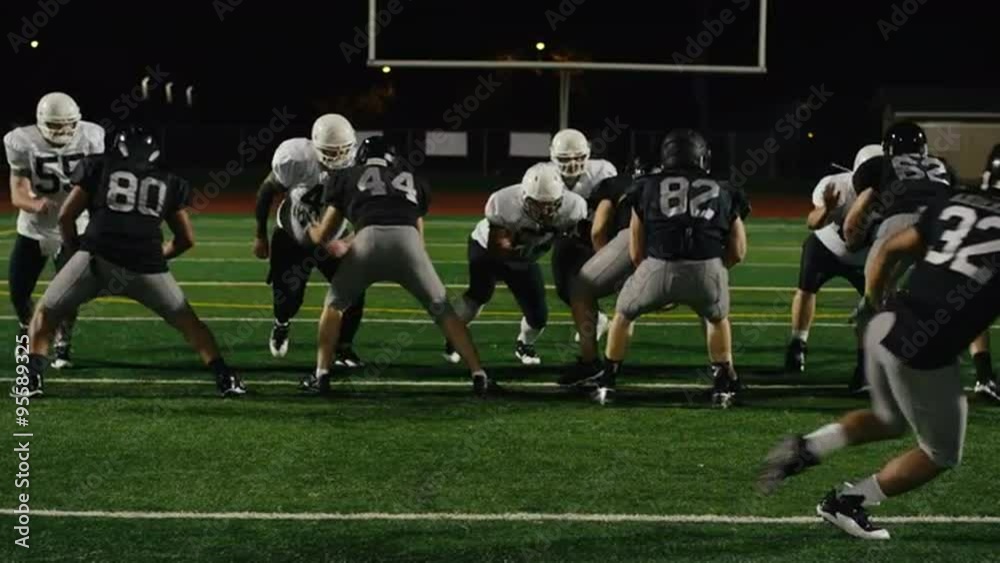 A football player gets tackled right before throwing the ball