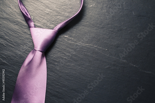 Elegant tie on dark background photo