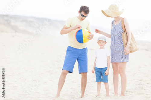 family of three at the beach