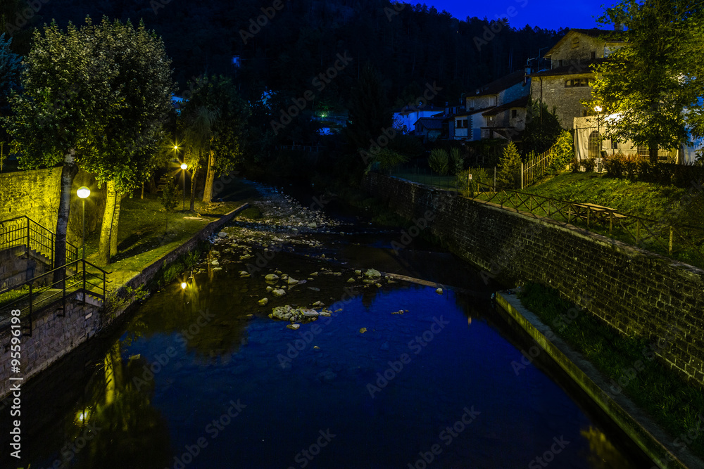river through mountain village in Tuscany