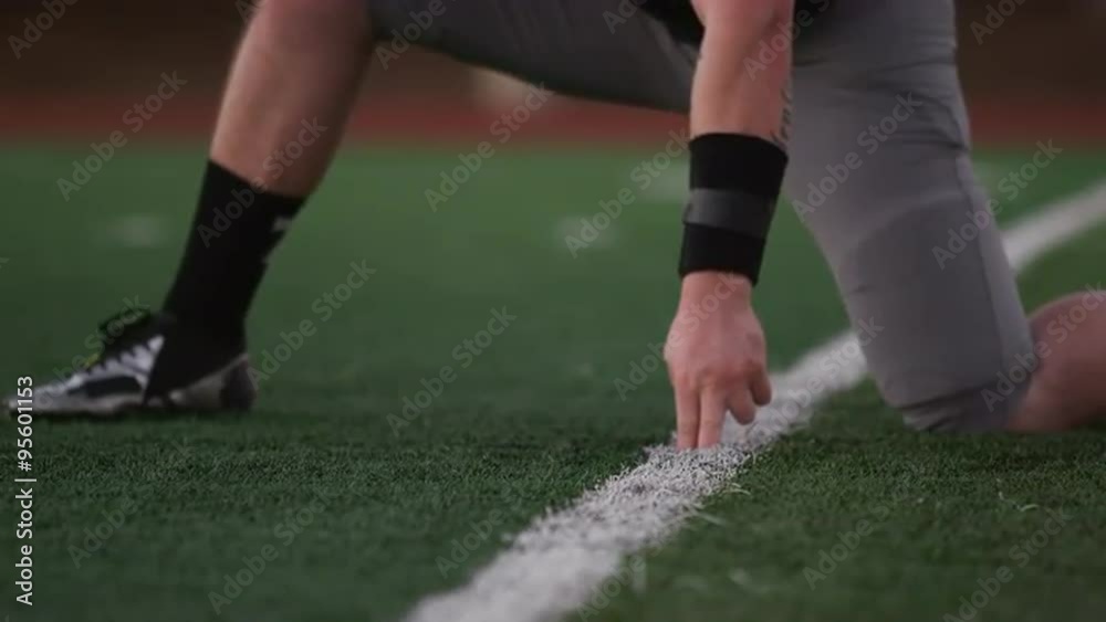 Close up of a football player kicking the ball toward the goal posts Close up of a football player kicking the ball toward the goal posts