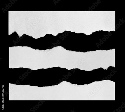 Piece of torn paper on black. Copy space