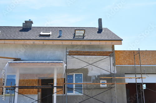 Construction or Repair of the Rural House with Skylights, Ventilation, Eaves, Windows, Garage, Doorway, Chimney, Roofing, Fixing Facade, Insulation, Plastering and Using Color. photo