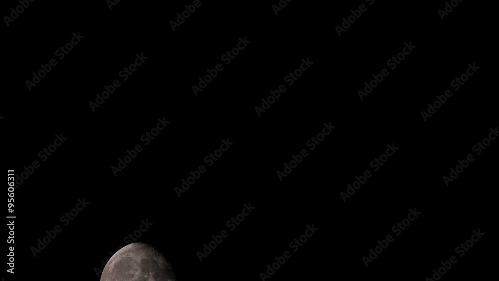 Time lapse of an large moon as it rises in the black night sky Time lapse of an large moon as it rises in the black night sky