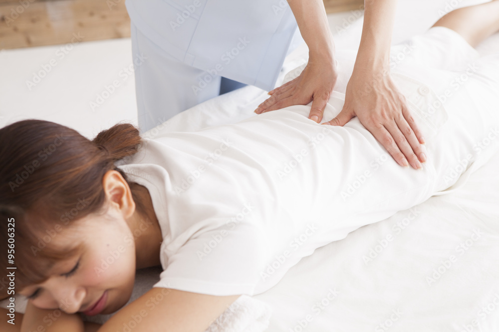 Young women are receiving a massage in a prone Young women are receiving a massage in a prone