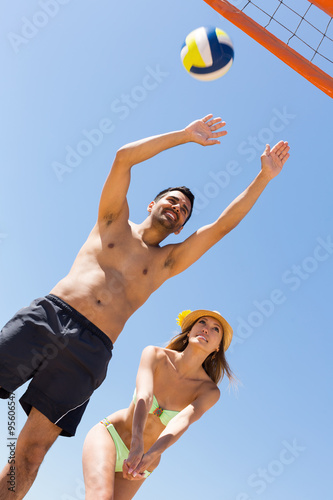 Adults people playing volleyball at beach