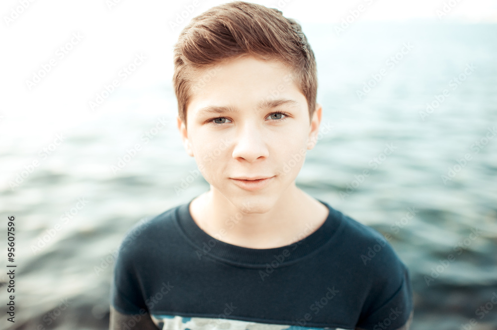 Teenage blond boy 14-16 year old posing over sea background. Looking at  camera. Teenager. Stylish hairstyle. Stock Photo | Adobe Stock