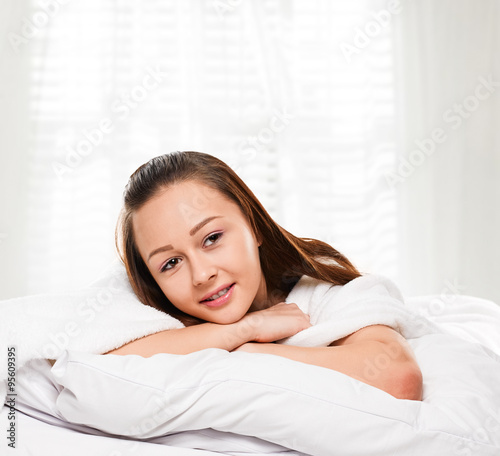 Portrait of the smiling woman in bed
