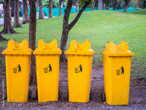 Yellow trashbins in the park photo