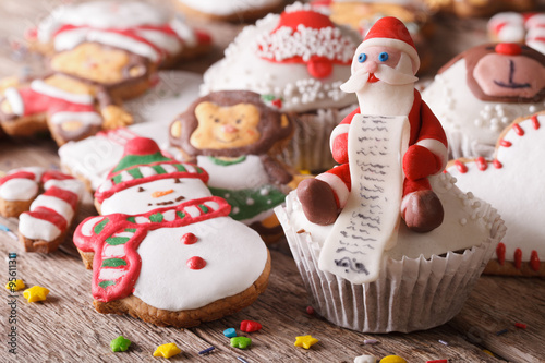 Christmas cupcakes and gingerbread macro on a wooden table. horizontal
