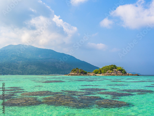 Small island in tropical sea with blue sky